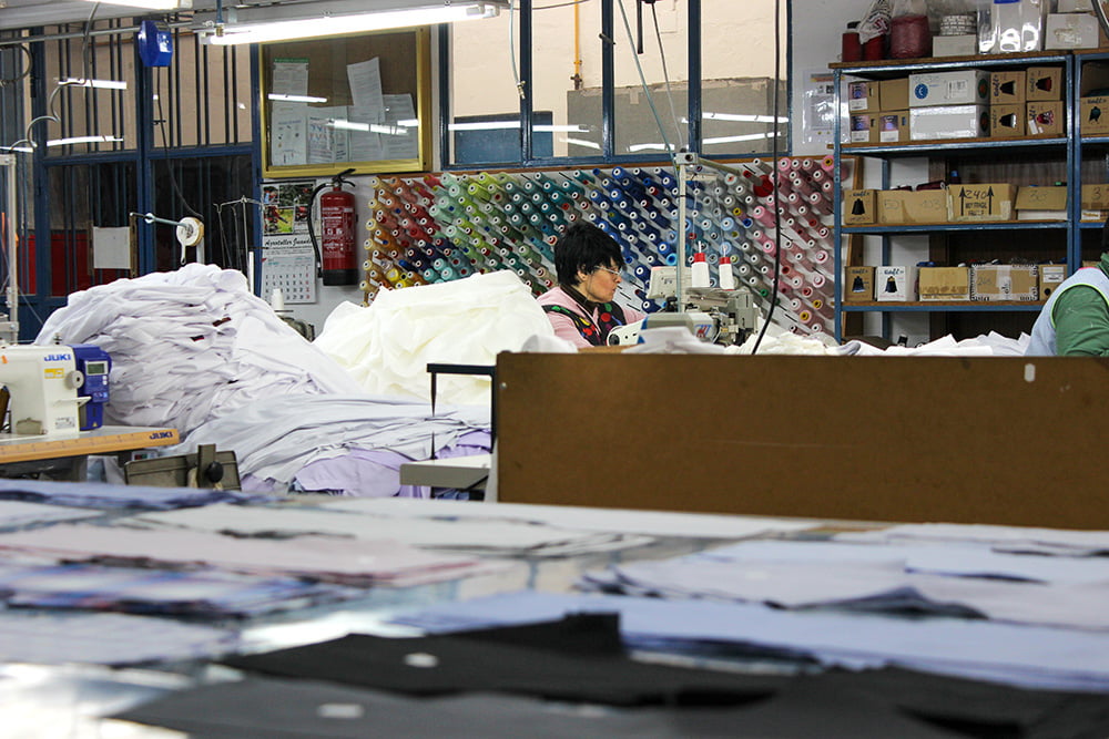 a woman sitting in a factory